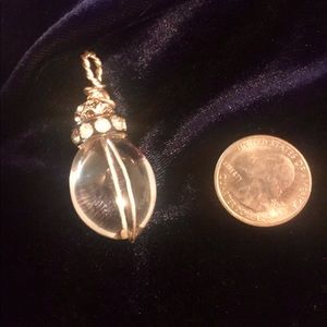 Clear crystal quartz pendant with rhinestones.